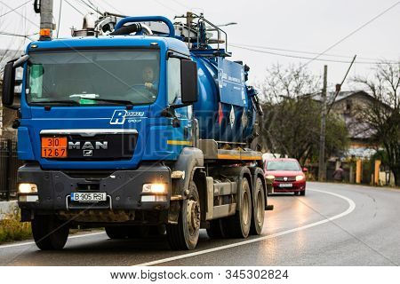 Cars On The Asphalt Road. Utility Car (from Rohrer Group Company) In Traffic.  Targoviste, Romania,