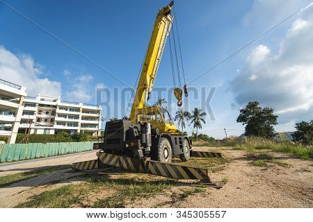 Yellow Automobile Crane With Risen Telescopic Boom Outdoors. Mobile Construction Crane On A Construc