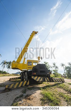 Yellow Automobile Crane With Risen Telescopic Boom Outdoors. Mobile Construction Crane On A Construc