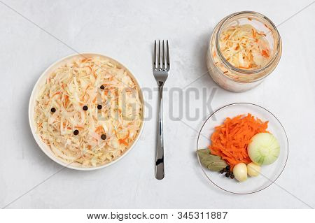 Homemade Sauerkraut. Fermented Food. Sauerkraut With Carrots In A Bowl And Glass Jar On A Concrete W