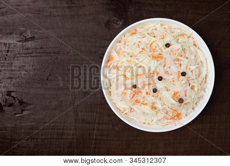 Homemade Sauerkraut. Fermented Food. Sauerkraut With Carrots In A Bowl On A Dark Wooden Background. 