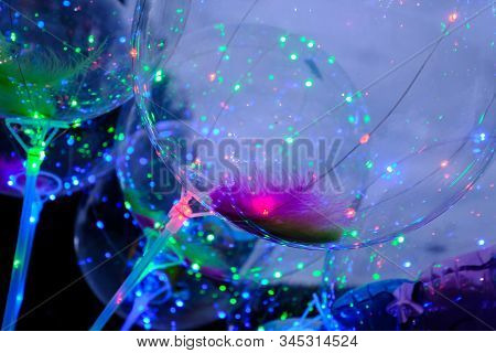 Defocused Image Of Neon Lights Of Illuminated Balloons Filled With Hellium With Led Light At Night