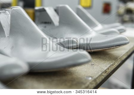 Plastic Lasts Used In The Manufacture Of Shoes. Row Of Plastic Shoe Lasts Used To Manufacture Modern