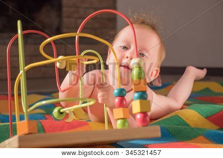 Fine Motor Challenge. Baby Plays With Toy. Montessori Background. Supporting The Development Of Fine