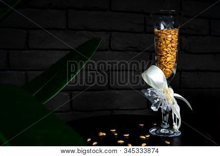 Glass Of Seal Wax Beads. Bright Colored Granules. Wooden Background.pearls Wax For Depilation. Depil
