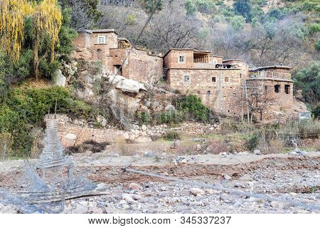 Berber Village By River In Atlas Mountains, Morocco