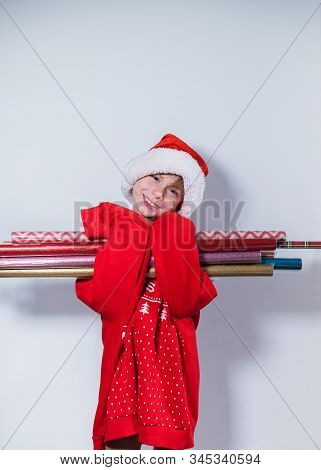 Charming Boy Wearing Santa's Hat In Red Sweater