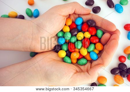 Tambov, Russian Federation - December 05, 2019 M&ms Candy In Woman Hands. White Background.