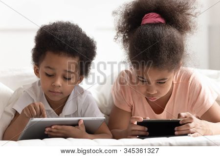 Tech Addicted Children Using Smartphone And Tablet.