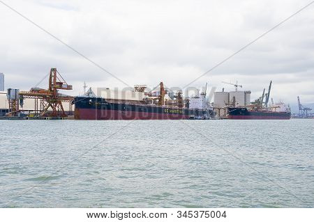 Santos - Sp, Brazil - November 21, 2019: Cargo Ships Docked On The Harbor On The Coast Of The City.