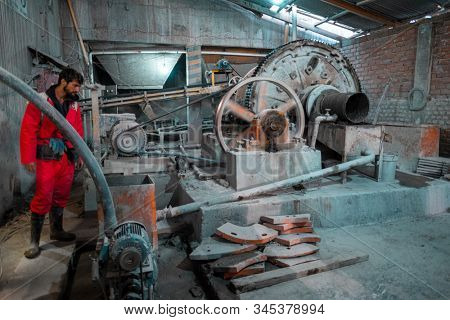 POTOSI / BOLIVIA - APRIL 02, 2018: Tourist watches the process of silver mining in the factory located near the mountain of Cerro Rico in the city of Potosi