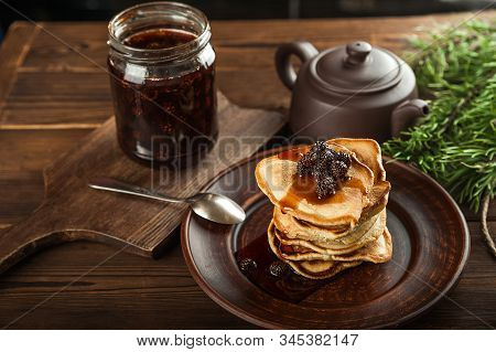 Siberian Dessert - Young Pine Cones Jam. Ukrainian Cone Jam In A Jar On A Dark Background Close-up A