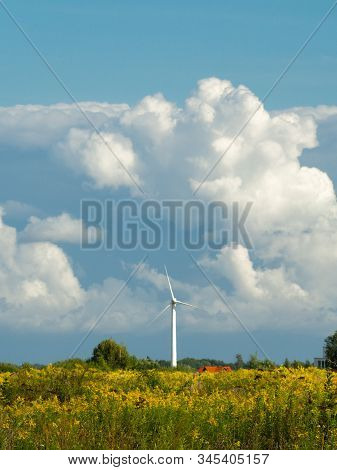 Wind Turbine Farm At The Field With Stormy Clouds. Wind Power For Electricity, Clean Energy. Baltic 