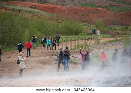 Tourists Visiting Strokkur Geyser In Iceland