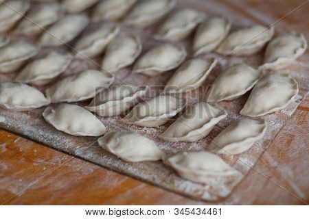 Vareniki, Dumplings With Potatoes On White Background - Traditional Ukrainian Food. Cooking Raw Dump
