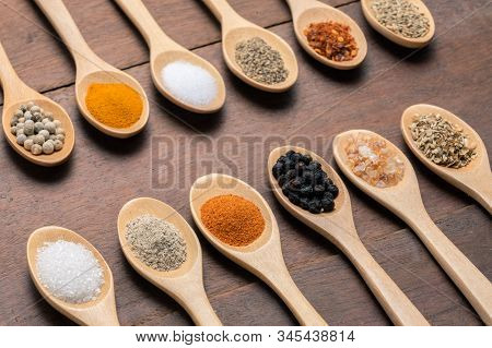 Various Spices In Wooden Spoon On Wood Table Background, Sugar, Pepper, Salt, Turmeric, Rosemary, Or