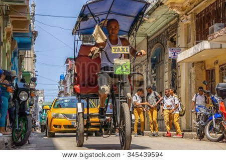Havana, Cuba - May 16, 2019: Bicycle Taxi Driver In The Street Of Old Havana City During A Vibrant A