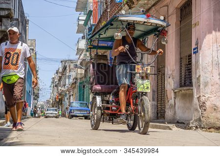 Havana, Cuba - May 16, 2019: Bicycle Taxi Driver In The Street Of Old Havana City During A Vibrant A