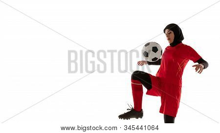 Arabian Female Soccer Or Football Player Isolated On White Studio Background. Young Woman Kicking Th
