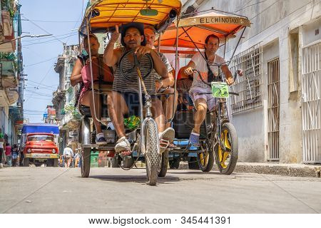 Havana, Cuba - May 16, 2019: Bicycle Taxi Driver In The Street Of Old Havana City During A Vibrant A