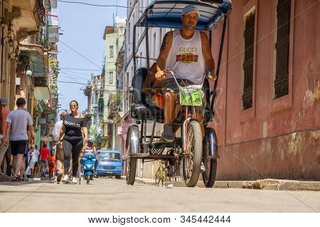 Havana, Cuba - May 16, 2019: Bicycle Taxi Driver In The Street Of Old Havana City During A Vibrant A