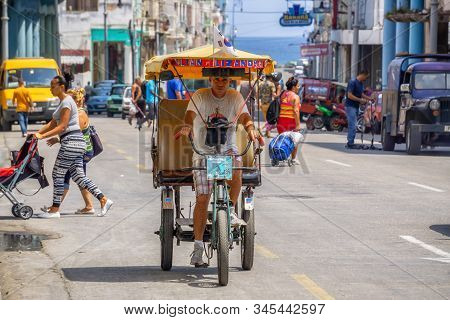 Havana, Cuba - May 16, 2019: Bicycle Taxi Driver In The Street Of Old Havana City During A Vibrant A