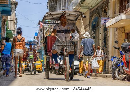 Havana, Cuba - May 16, 2019: Bicycle Taxi Driver In The Street Of Old Havana City During A Vibrant A