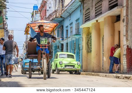 Havana, Cuba - May 16, 2019: Bicycle Taxi Driver In The Street Of Old Havana City During A Vibrant A