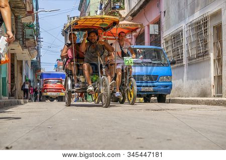 Havana, Cuba - May 16, 2019: Bicycle Taxi Driver In The Street Of Old Havana City During A Vibrant A