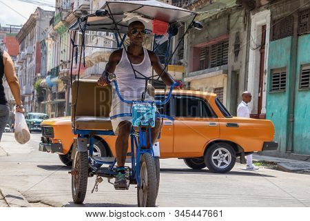 Havana, Cuba - May 16, 2019: Bicycle Taxi Driver In The Street Of Old Havana City During A Vibrant A
