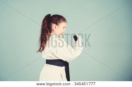Power And Balance. Sport Success In Single Combat. Small Girl In Martial Arts Uniform. Practicing Ku