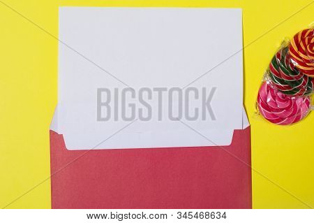 Opened Red Envelope With A White Letter With Spare Space And Colorful Candy