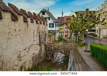 Old Street In Zug City Along Defence Wall And Water Duct Of Burg Zug, Switzerland