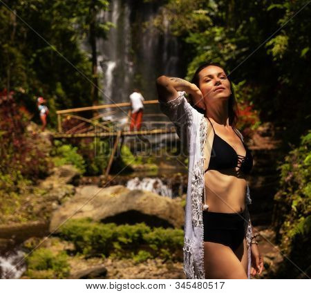 Woman near Labuhan Kebo Waterfall located in Munduk, Bali