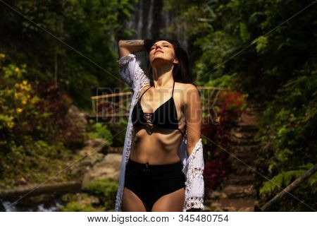 Woman near Labuhan Kebo Waterfall located in Munduk, Bali