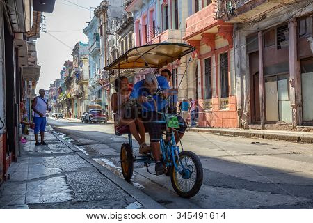 Havana, Cuba - May 13, 2019: Bicycle Taxi Driver Riding In The Streets Of Old Havana City During A V