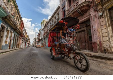 Havana, Cuba - May 14, 2019: Bicycle Taxi Driver Riding In The Streets Of Old Havana City During A V