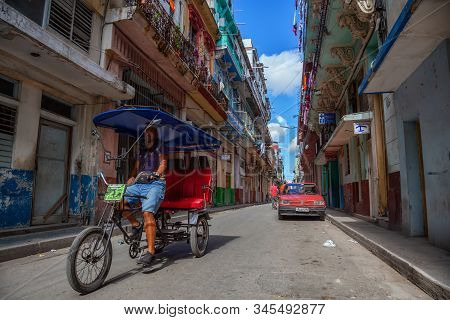 Havana, Cuba - May 13, 2019: Bicycle Taxi Driver Riding In The Streets Of Old Havana City During A V