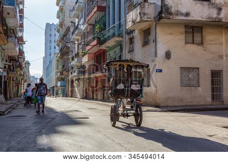 Havana, Cuba - May 13, 2019: Bicycle Taxi Driver Riding In The Streets Of Old Havana City During A V
