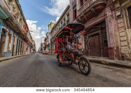 Havana, Cuba - May 14, 2019: Bicycle Taxi Driver Riding In The Streets Of Old Havana City During A V