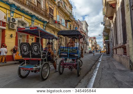 Havana, Cuba - May 13, 2019: Bicycle Taxi Driver Riding In The Streets Of Old Havana City During A V