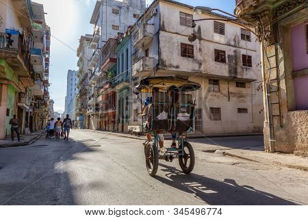 Havana, Cuba - May 13, 2019: Bicycle Taxi Driver Riding In The Streets Of Old Havana City During A V