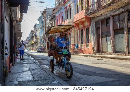 Havana, Cuba - May 13, 2019: Bicycle Taxi Driver Riding In The Streets Of Old Havana City During A V