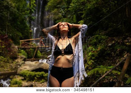 Woman near Labuhan Kebo Waterfall located in Munduk, Bali