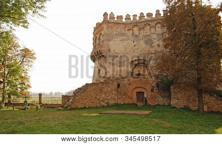 The Round Tower Of The Ostrog Castle In Western Ukraine. Bottom View Of The Walls