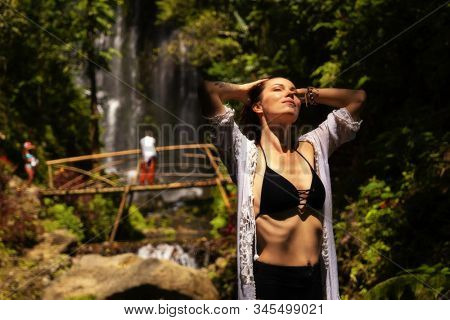 Woman near Labuhan Kebo Waterfall located in Munduk, Bali