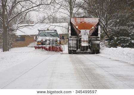 Snow Plow Removing Snow From City Street.
