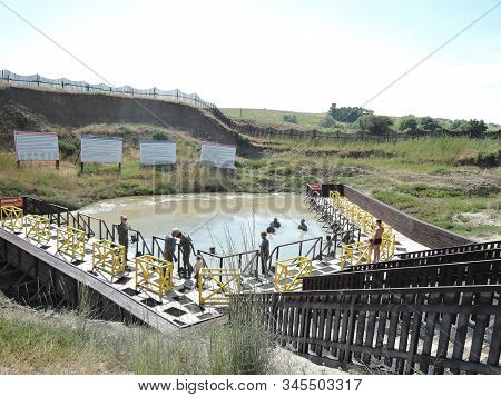 Temryuk District, Russia - June 2018: Unknown Happy Campers Bathing In The Mud Volcano Tizdar On The