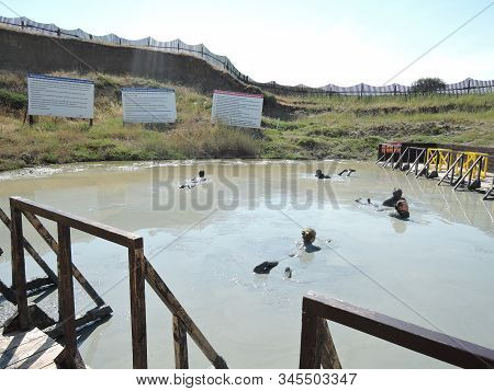 Temryuk District, Russia - June 2018: Unknown Happy Campers Bathing In The Mud Volcano Tizdar On The