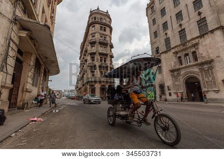 Havana, Cuba - May 14, 2019: Bicycle Taxi Driver Riding In The Streets Of Old Havana City During A C